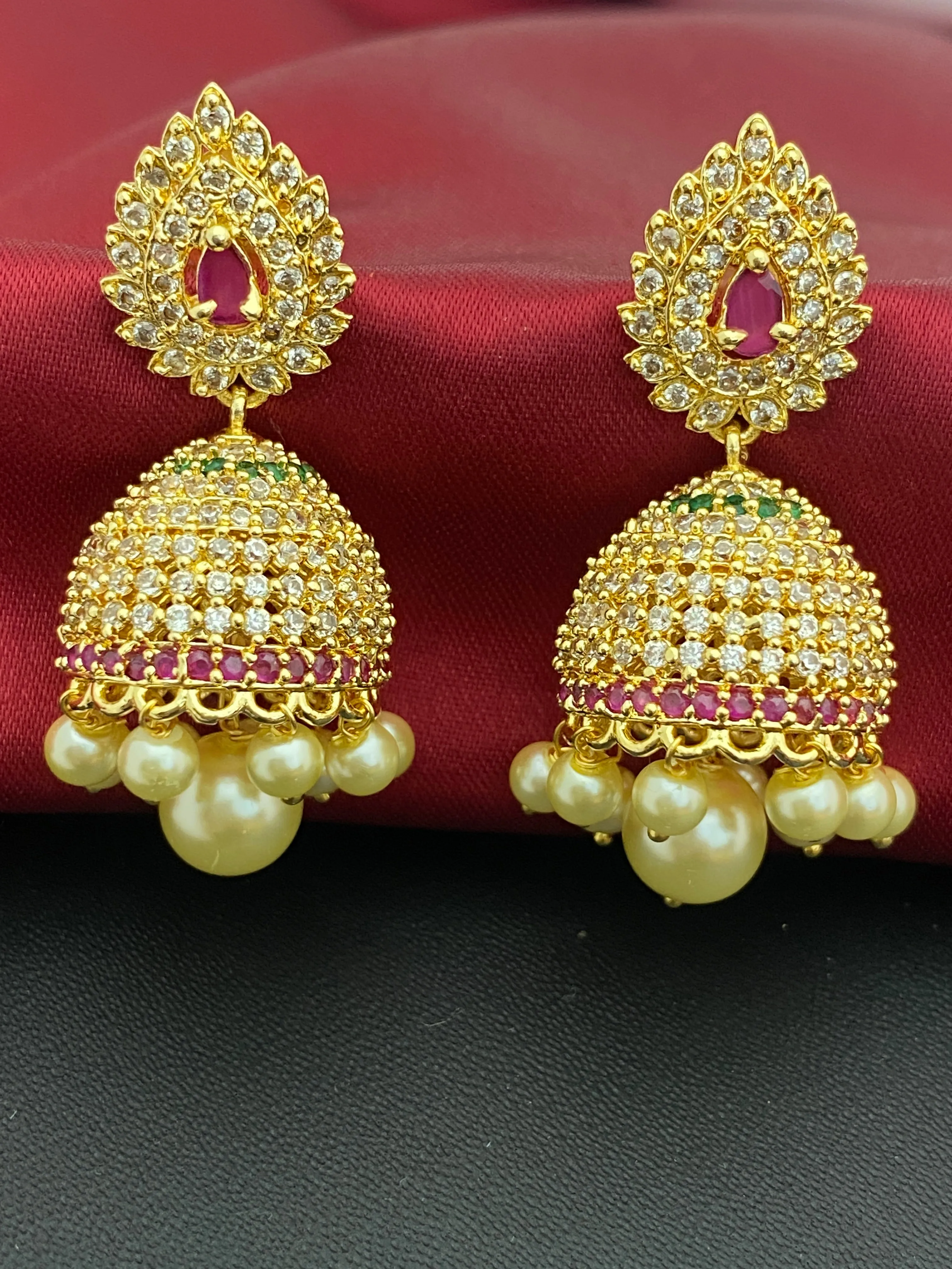 Splendid Traditional Wear Gold plated Jhumka Earrings With Pearl Drops