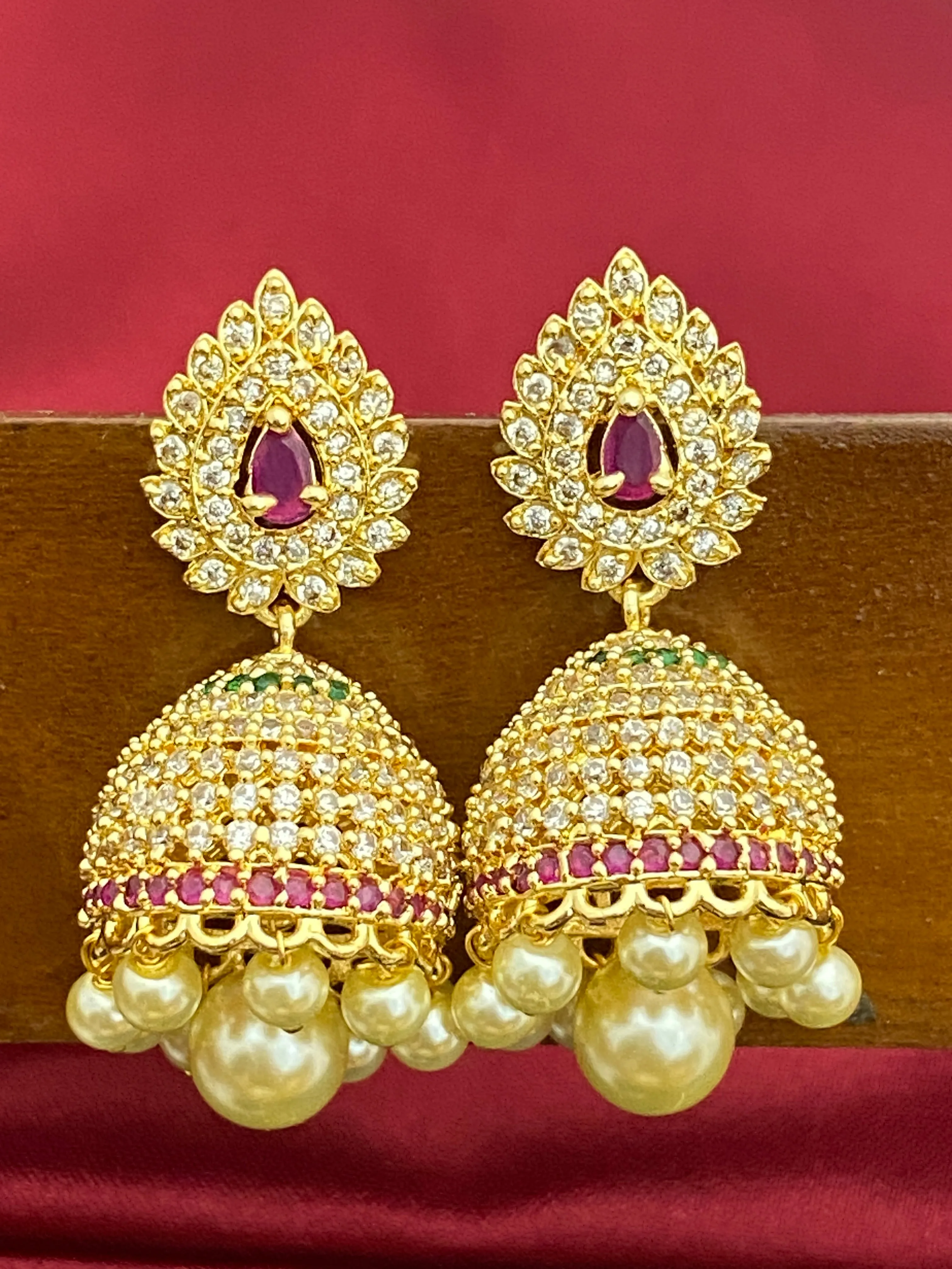 Splendid Traditional Wear Gold plated Jhumka Earrings With Pearl Drops